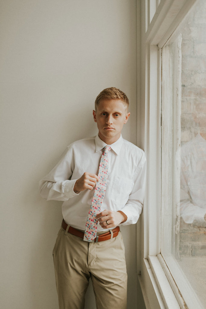Hermosa tie worn with a white shirt, brown belt and khaki pants.