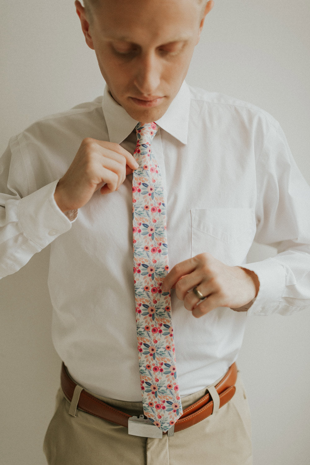 Hermosa tie worn with a white shirt, brown belt and khaki pants.