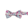 Hermosa Pre-Tied Bow Tie. Cream/off white background with pink and peach circular flowers and blue and green leaves throughout.