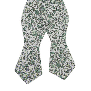 Hidden Garden Self Tie Bow Tie. White background with sage green flowers and leaves with black vines.