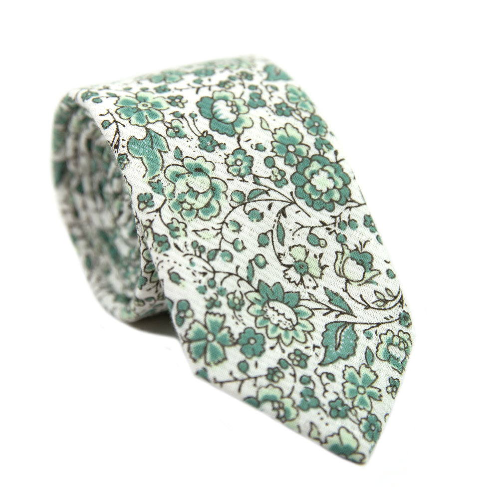 Hidden Garden Skinny Tie. White background with sage green flowers and leaves with black vines.
