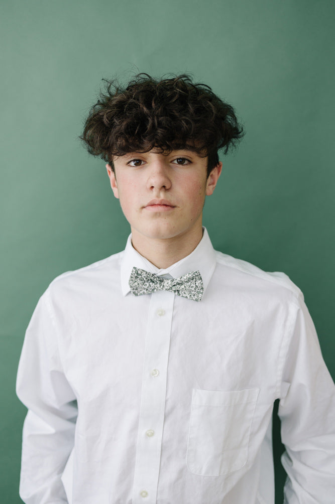 Hidden Garden pre-tied bow tie worn with a long sleeve white shirt.