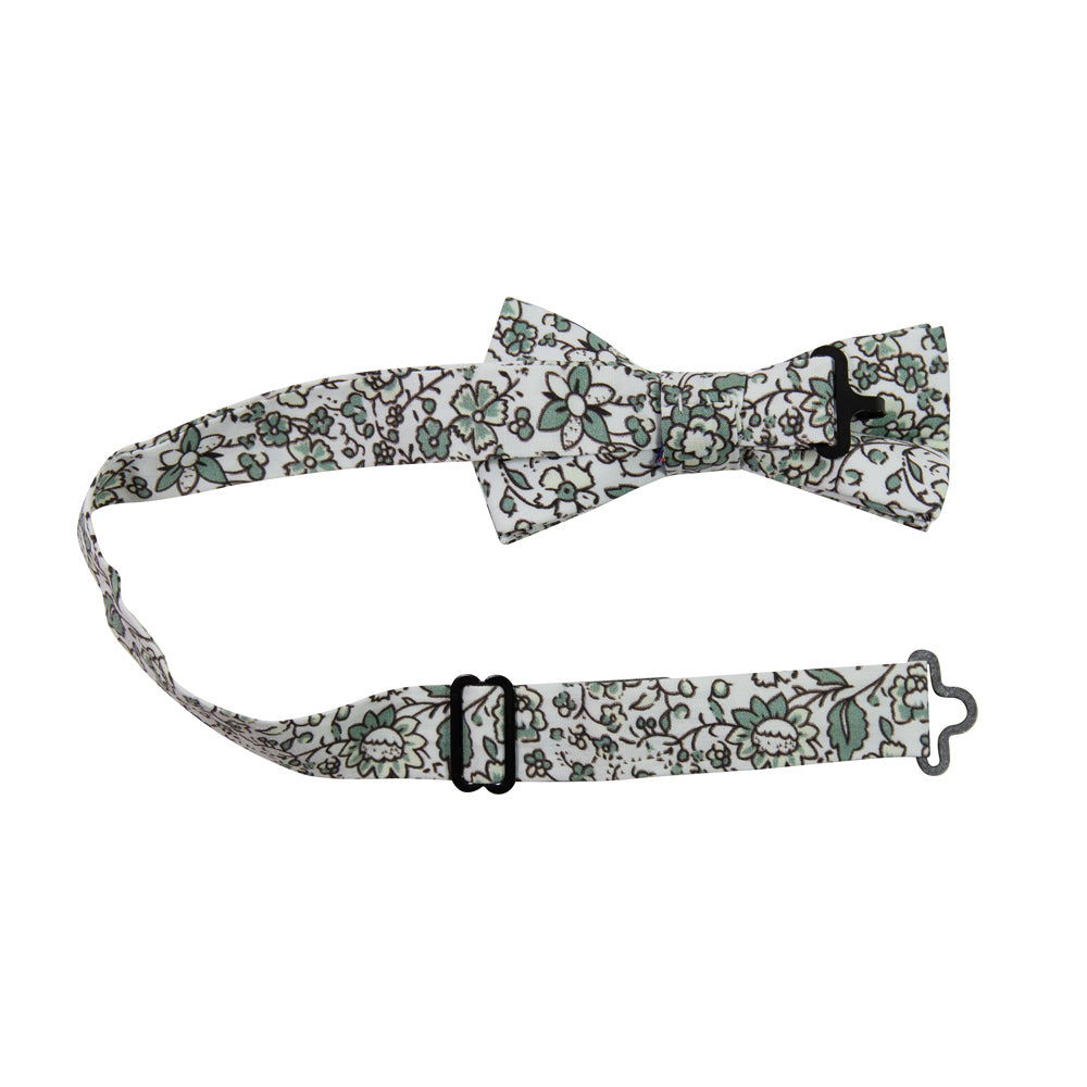 Hidden Garden Pre-Tied Bow Tie with adjustable neck strap. White background with sage green flowers and leaves with black vines.