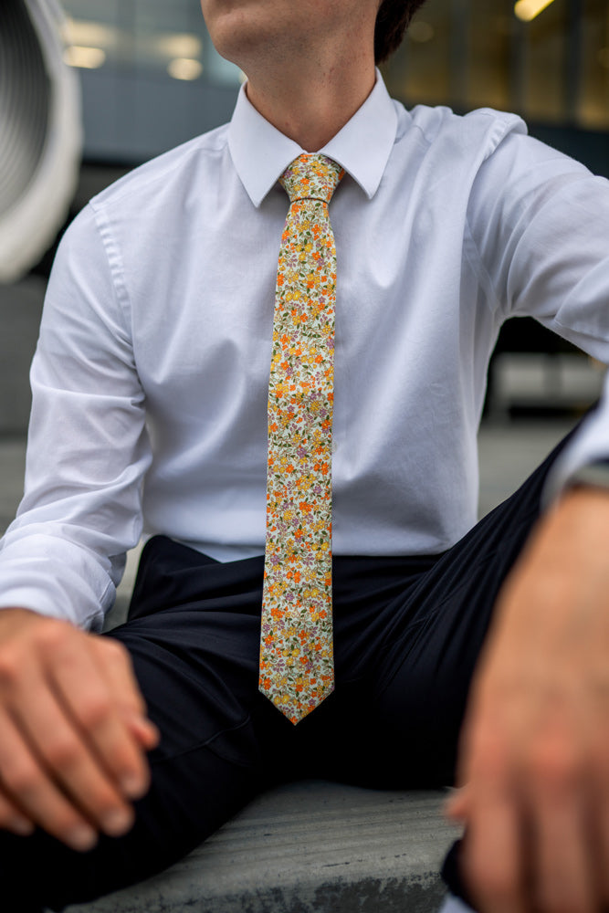 Honey skinny tie worn with a white shirt and black pants.