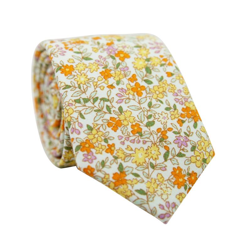 Honey Skinny Tie. Off white background with small yellow, orange, and pink flowers throughout. 