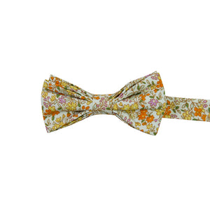 Honey Pre-Tied Bow Tie. Off white background with small yellow, orange, and pink flowers throughout. 