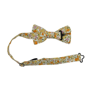 Honey Pre-Tied Bow Tie with adjustable neck strap. Off white background with small yellow, orange, and pink flowers throughout. 