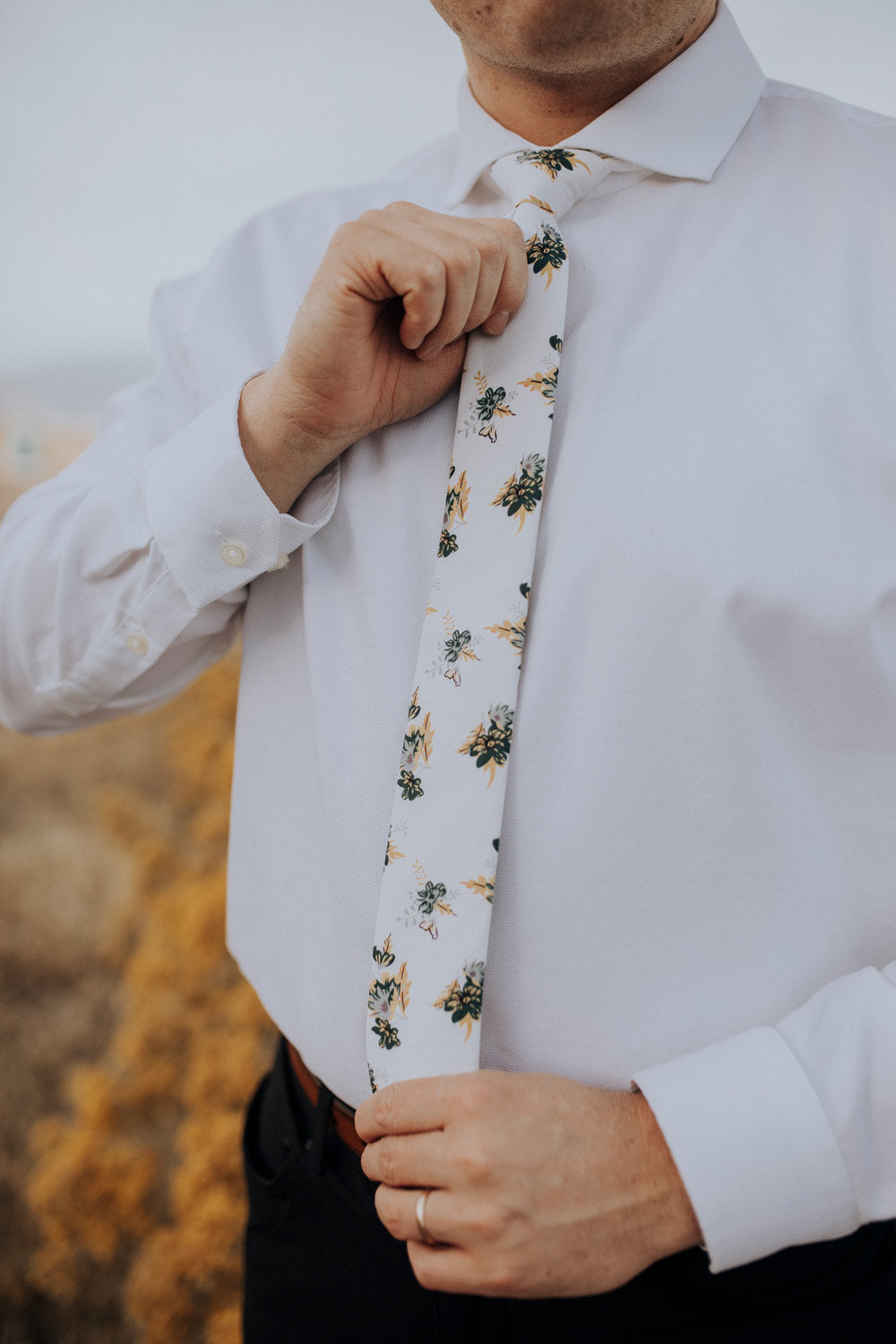 Honeysuckle tie worn with a white shirt, brown belt and black pants.
