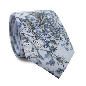 Indie Skye Skinny Tie. Dusty blue background with white, blue, black and gray floral leaf pattern.