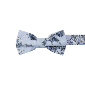 Indie Skye Pre-Tied Bow Tie. Dusty blue background with white, blue, black and gray floral leaf pattern.