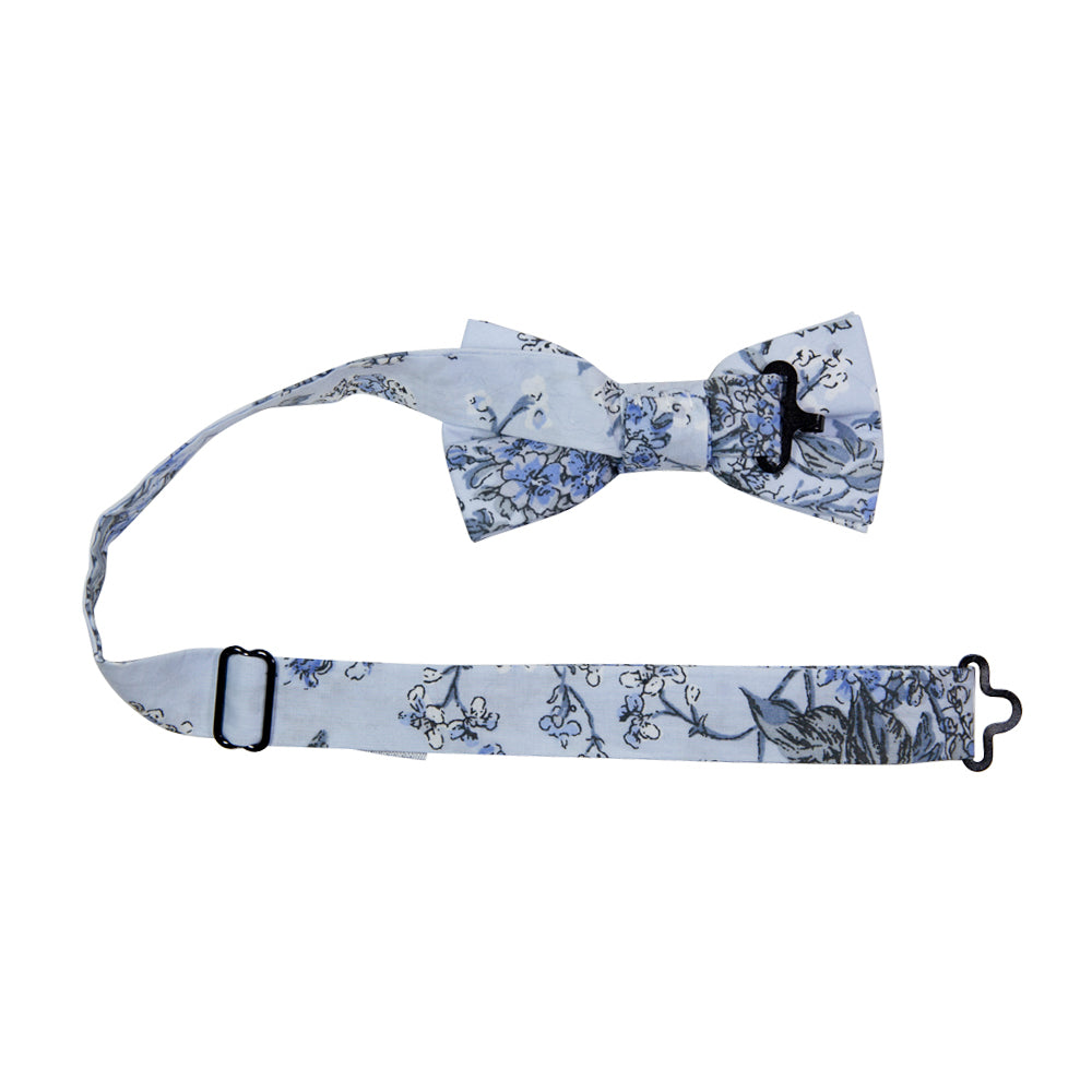 Indie Skye Pre-Tied Bow Tie with adjustable neck strap. Dusty blue background with white, blue, black and gray floral leaf pattern.