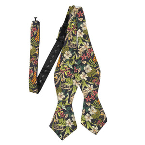 Jumanji Self Tie Bow Tie. Grayish background with white, green, red, orange and yellow jungle leaves over the entire tie.