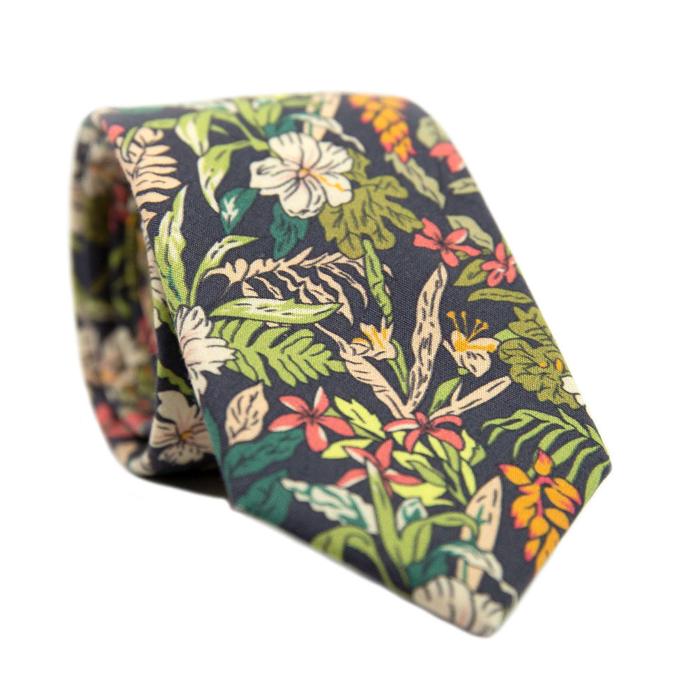 Jumanji Skinny Tie. Grayish background with white, green, red, orange and yellow jungle leaves over the entire tie.