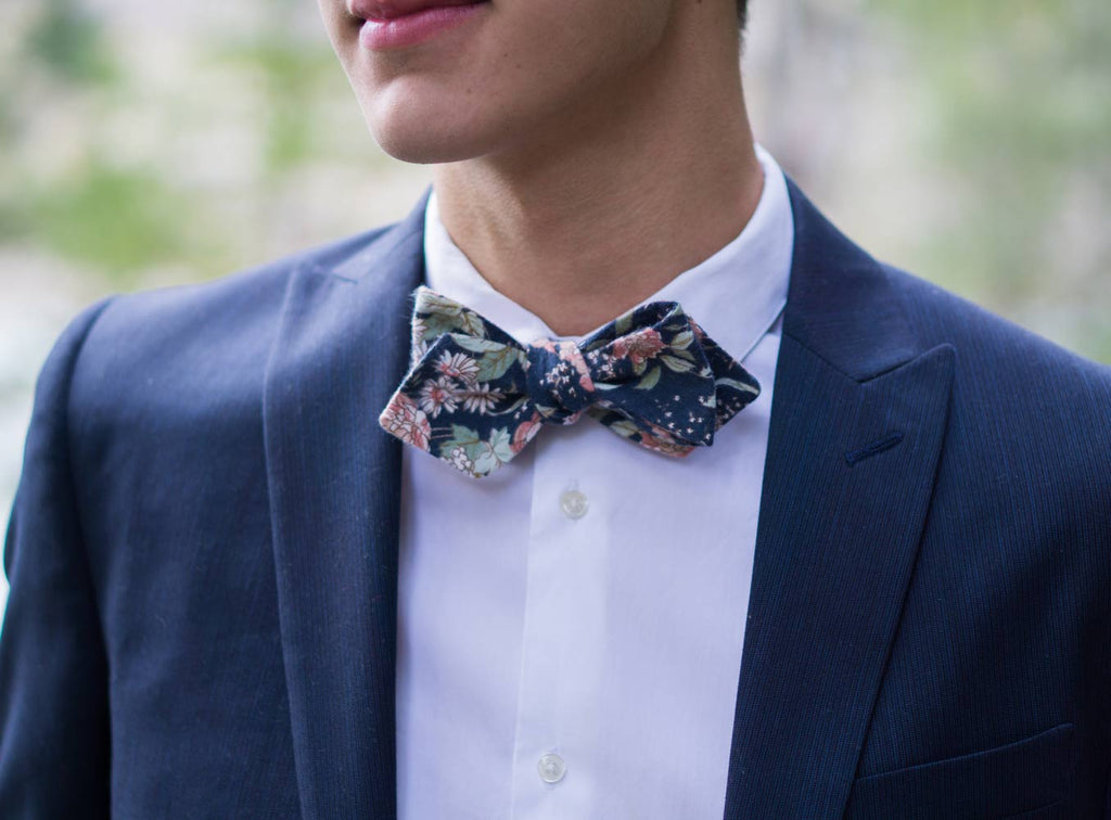 Lotus Bow Tie worn with a white shirt and navy suit jacket.