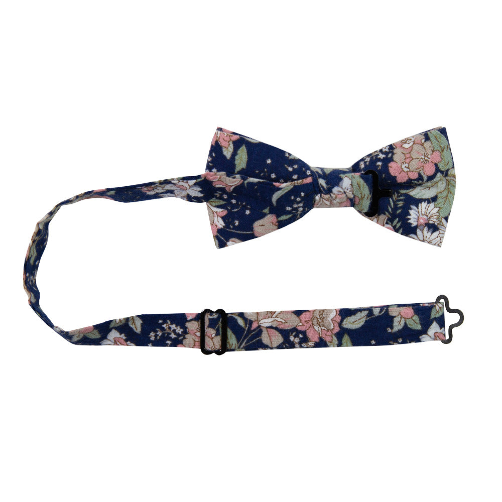 Lotus Pre-Tied Bow Tie with adjustable neck strap. Navy background with white and blush pink flowers and sage green stems and leaves.