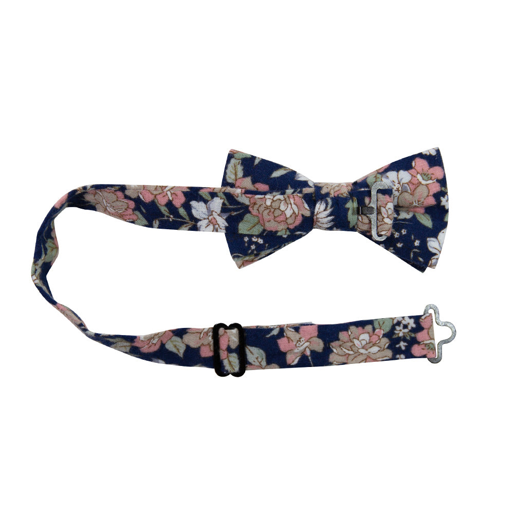 Lotus Pre-Tied Bow Tie with adjustable neck strap. Navy background with white and blush pink flowers and sage green stems and leaves.