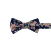Lotus Pre-Tied Bow Tie. Navy background with white and blush pink flowers and sage green stems and leaves.