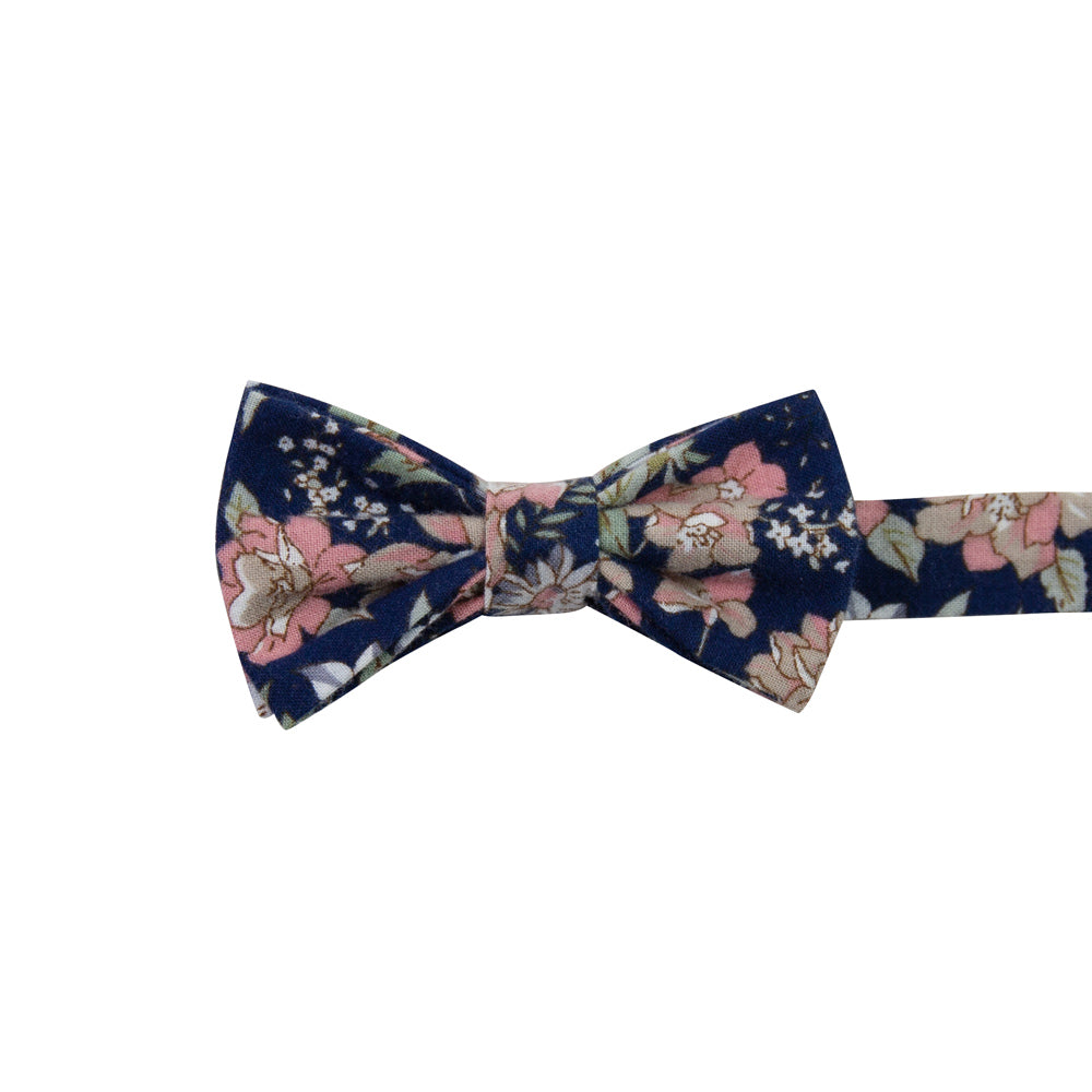 Lotus Pre-Tied Bow Tie. Navy background with white and blush pink flowers and sage green stems and leaves.