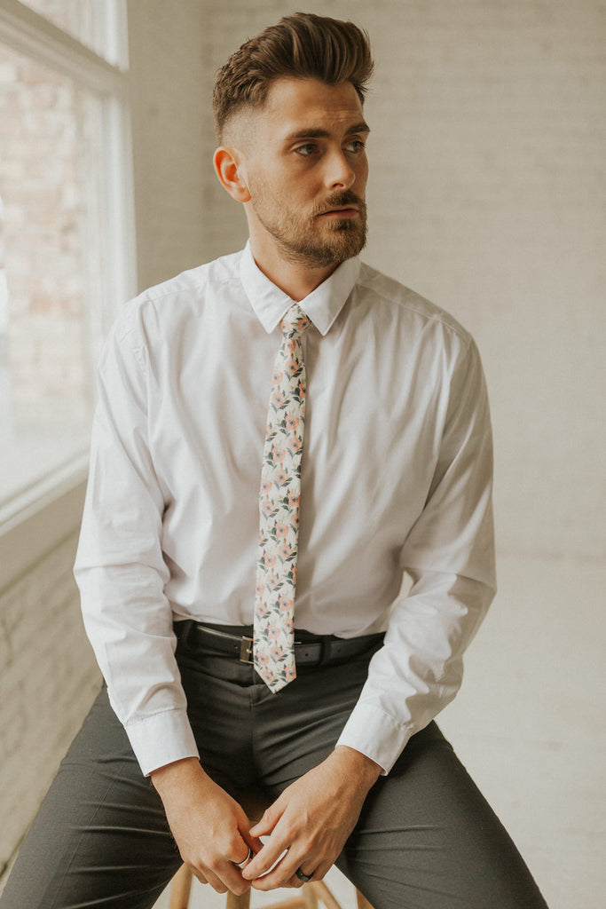 Magnolia tie worn with a white shirt, black belt and black pants.