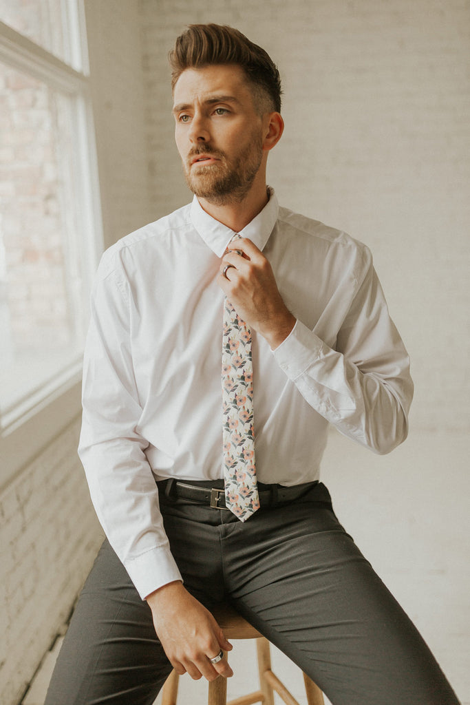 Magnolia tie worn with a white shirt, black belt and black pants.