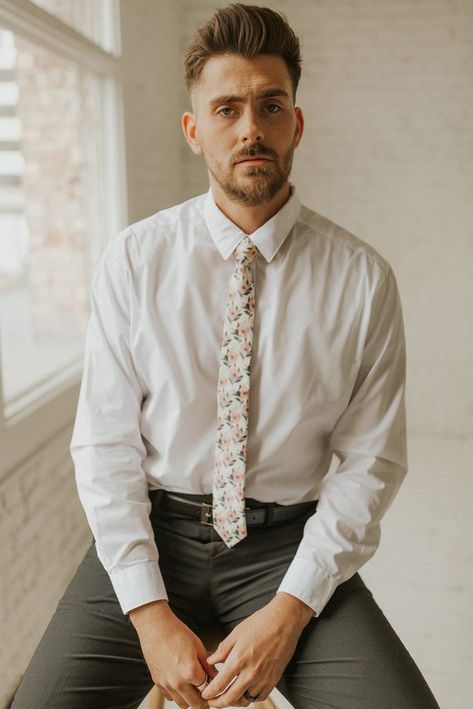 Magnolia tie worn with a white shirt, black belt and black pants.
