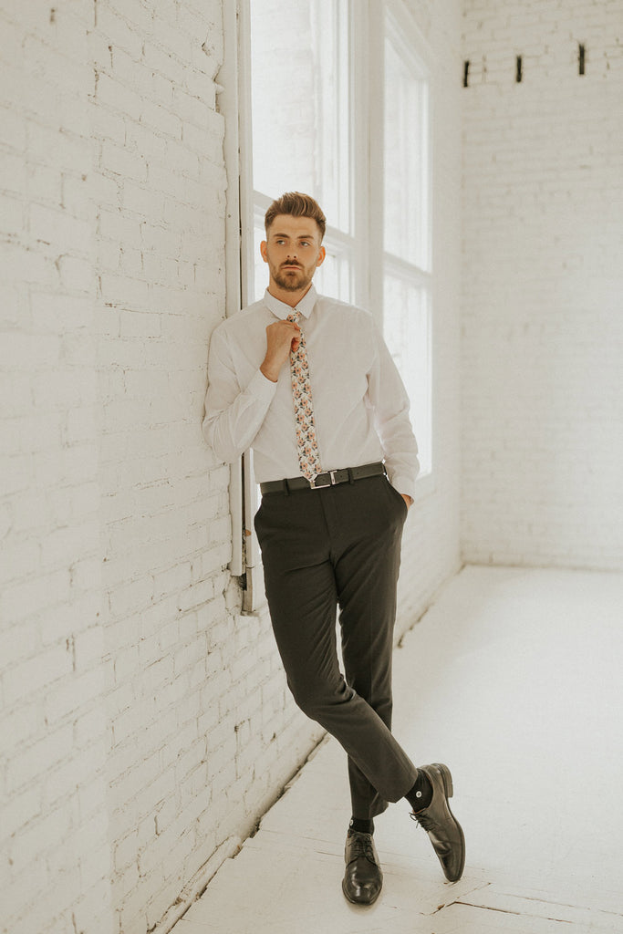 Magnolia tie worn with a white shirt, black belt and black pants.