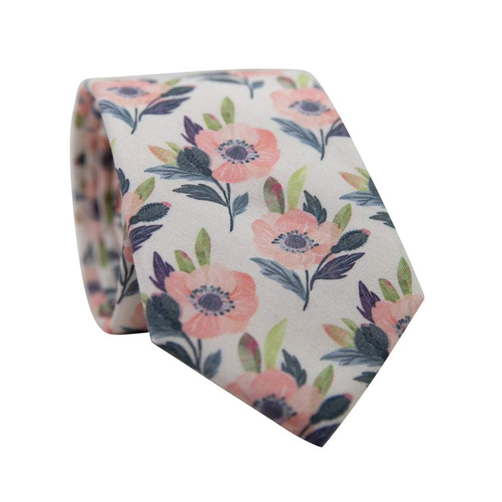 Magnolia Skinny Tie. Off white background with pink flowers and blue and green leaves. 