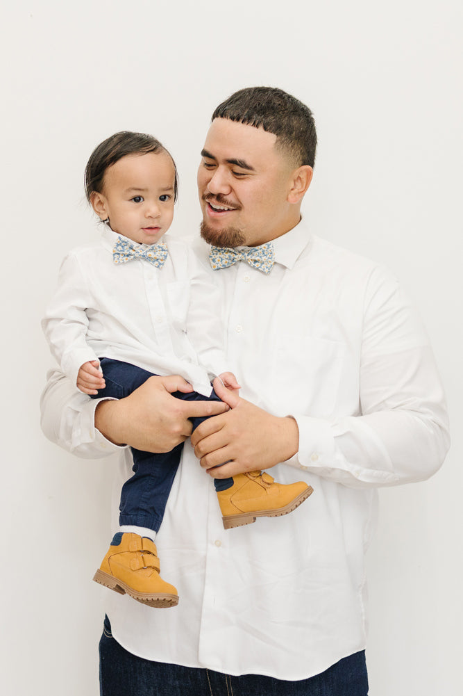 Mahalo pre-tied bow tie worn by a father and son with a white shirt and blue pants.