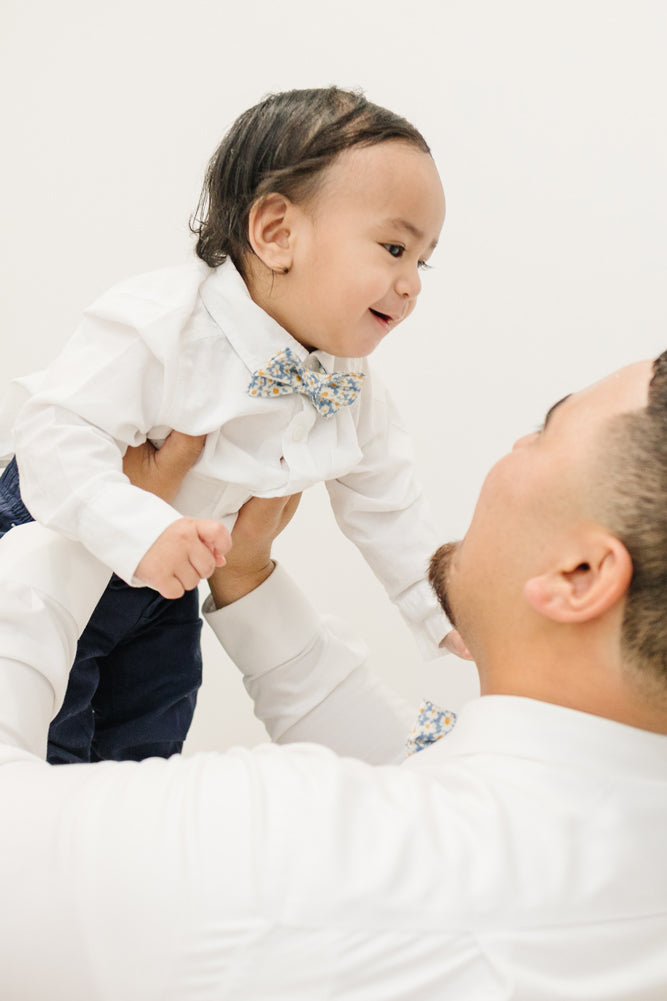 Mahalo pre-tied bow tie worn by a father and son with a white shirt and blue pants.