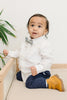 Mahalo pre-tied bow tie worn with a white shirt and blue pants, brown boots.