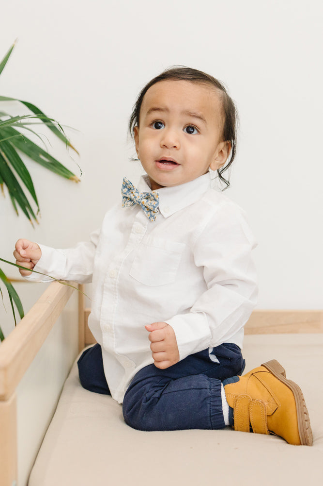 Mahalo pre-tied bow tie worn with a white shirt and blue pants, brown boots.