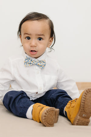 Mahalo pre-tied bow tie worn with a white shirt and blue pants, brown boots.