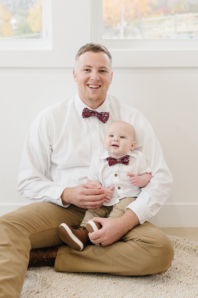 Mahogany pre-tied bow tie worn by a father and son with a white shirt and tan pants.