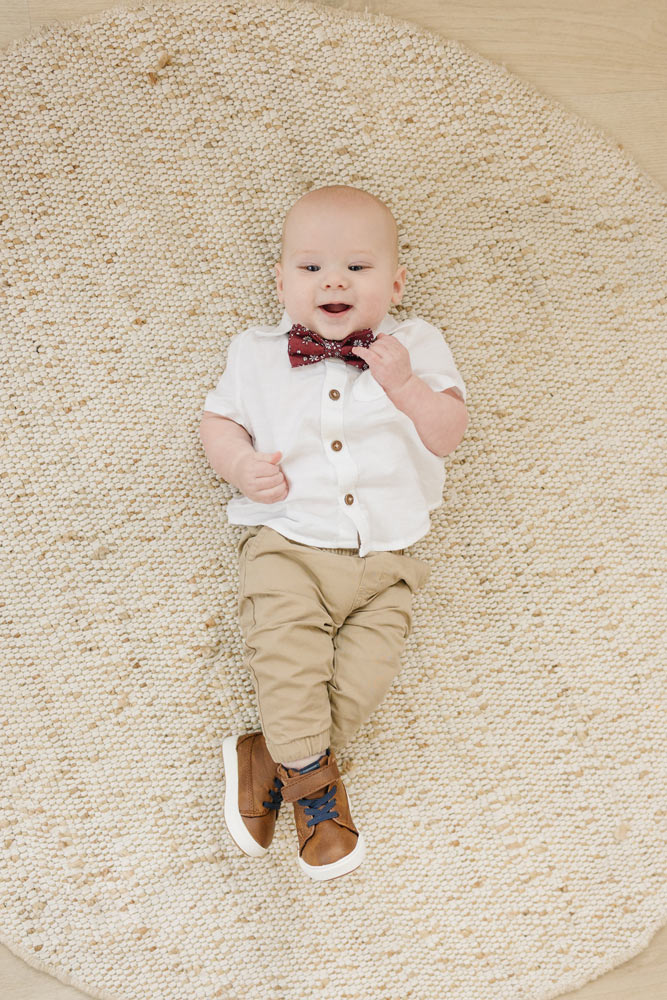 Mahogany pre-tied bow tie worn with a white shirt and tan pants, brown shoes.