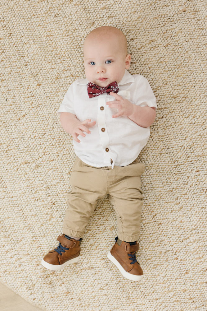 Mahogany pre-tied bow tie worn with a white shirt and tan pants, brown shoes.