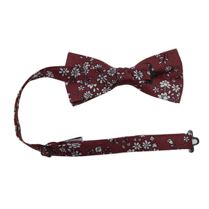 Mahogany Floral Pre-Tied Bow Tie with adjustable neck strap. Burgundy background with small white flowers and black stems throughout.