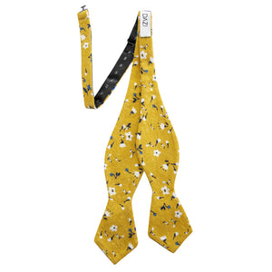 Marigold Self Tie Bow Tie. Yellow background with small white, black and blue flowers.