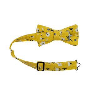 Marigold Pre-Tied Bow Tie with Adjustable Neck Strap. Yellow background with small white, black and blue flowers.