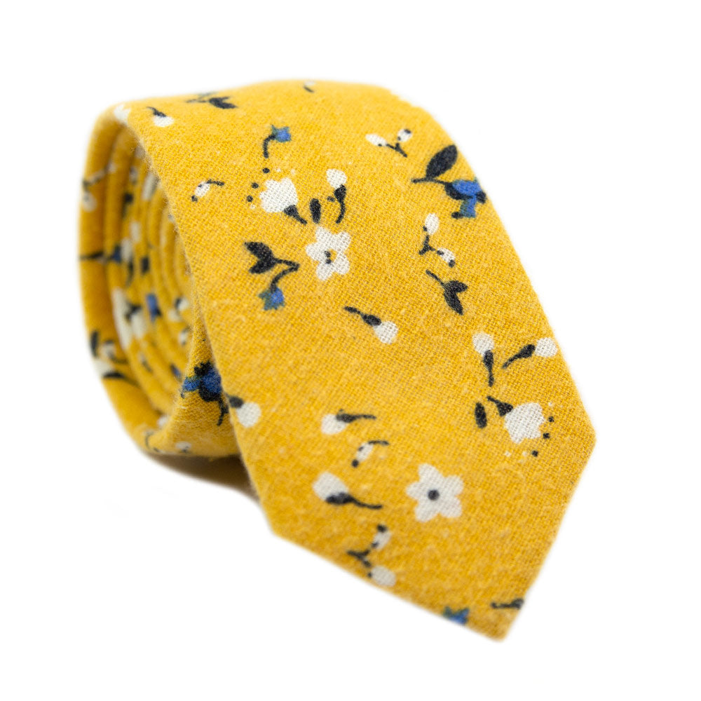 Marigold Skinny Tie. Yellow background with small white, black and blue flowers.