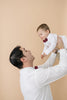 Merlot pre-tied bow ties worn by father and son in white long sleeve shirts. 