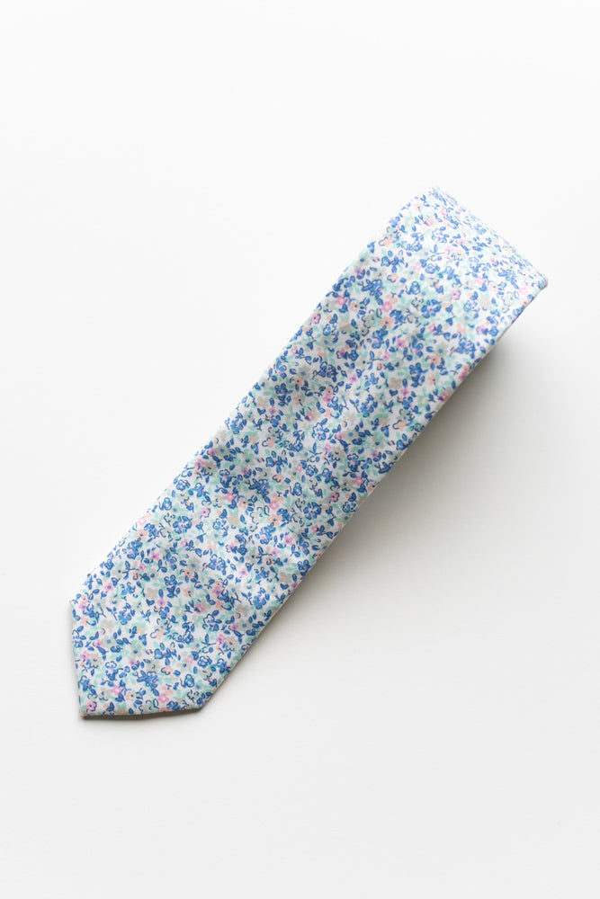 Misty Love tie rolled up on a white background.