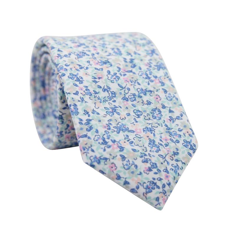 Misty Love Floral Skinny Tie. White background with small blue, green, and pink flowers and mint green and blue leaves throughout.