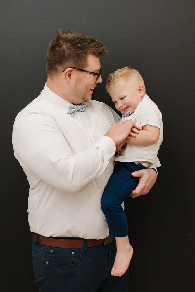 Misty Love pre-tied bow tie worn by a father and son with a white shirt and blue pants.