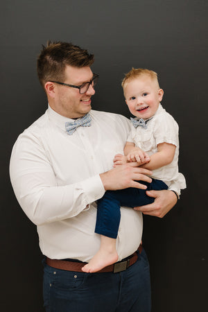 Misty Love pre-tied bow tie worn by a father and son with a white shirt and blue pants.