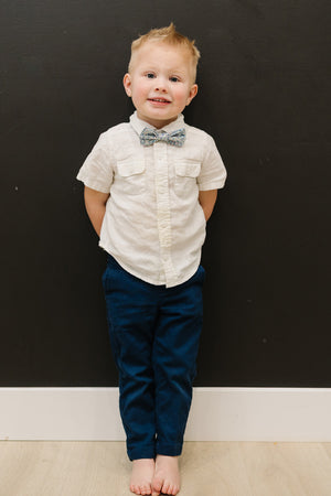 Misty Love pre-tied bow tie worn with a white shirt and blue pants.