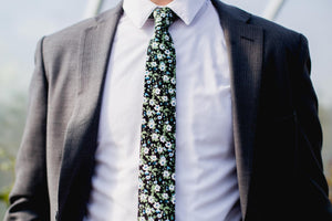 Morning Glory tie worn with a white shirt and dark navy suit jacket.