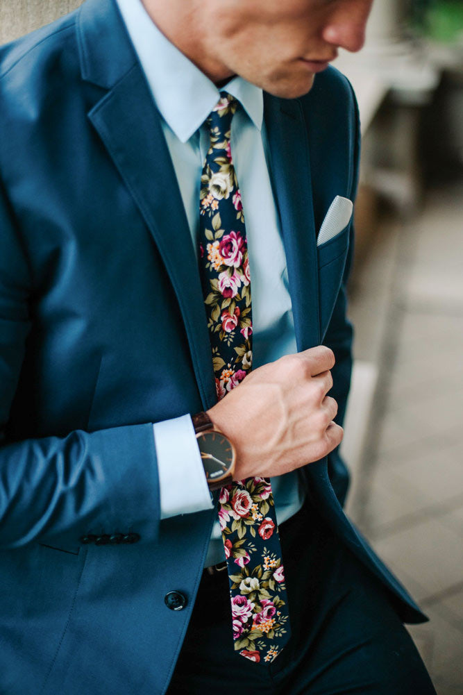Navy Blue Floral tie worn with a light blue shirt and blue suit. 