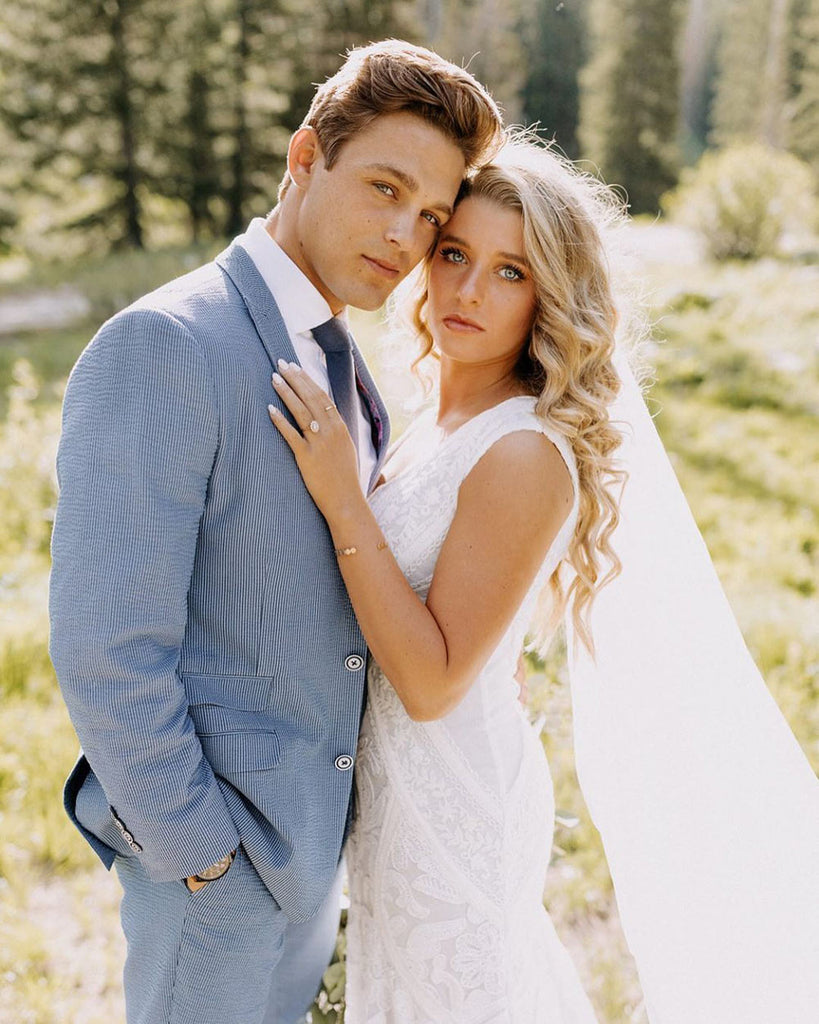 Navy tie worn with a white shirt and blue textured suit.