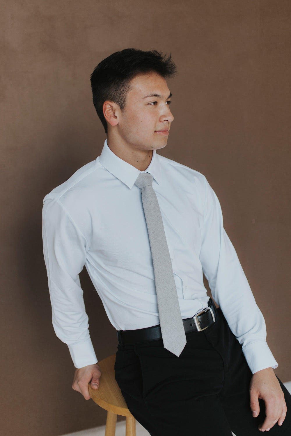 Onyx Tie worn with a white shirt and black pants.