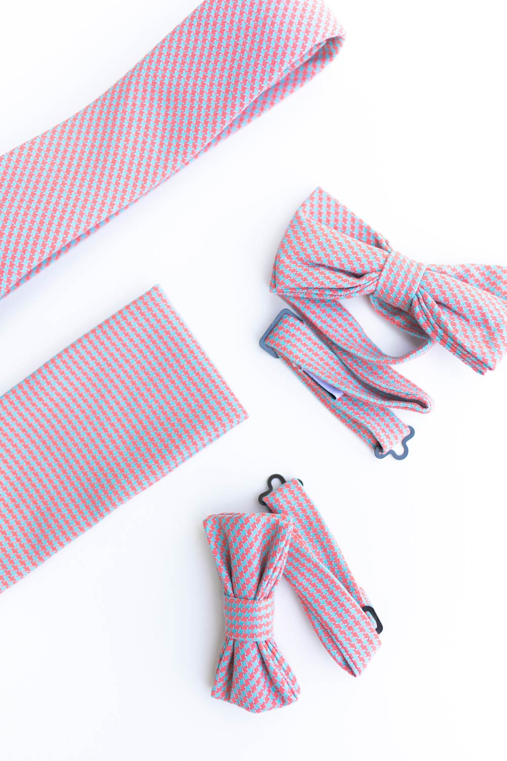 Opal weave pocket square photographed next to the matching tie and bow ties. 
